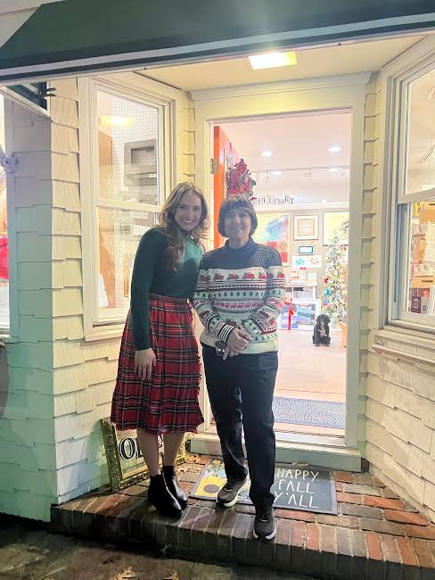 LuAnn Thompson, owner of Bellport Arts & Framing and co-president of the Bellport Chamber of Commerce, is pictured wearing a festive Christmas sweater with one of her employees, Christa Mingino, adorned in Christmas plaid.